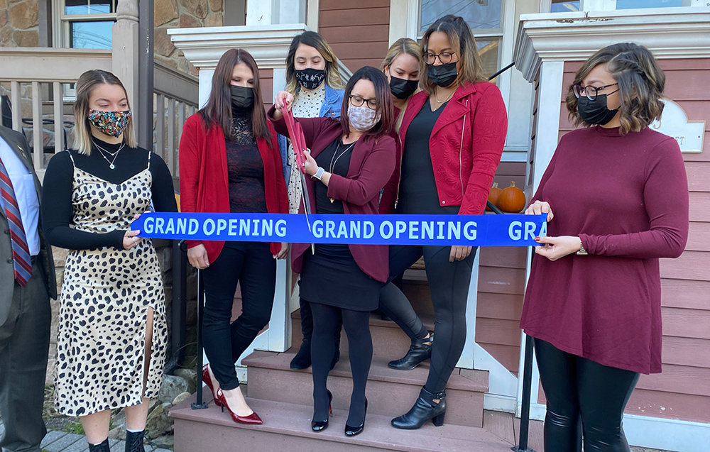 La Pêche owner Kate Bradatsch cuts the ribbon during a ceremony at her new location on Saturday. Her business recently moved from 201 Ward Street to 13 Union Street in the Village of Montgomery.